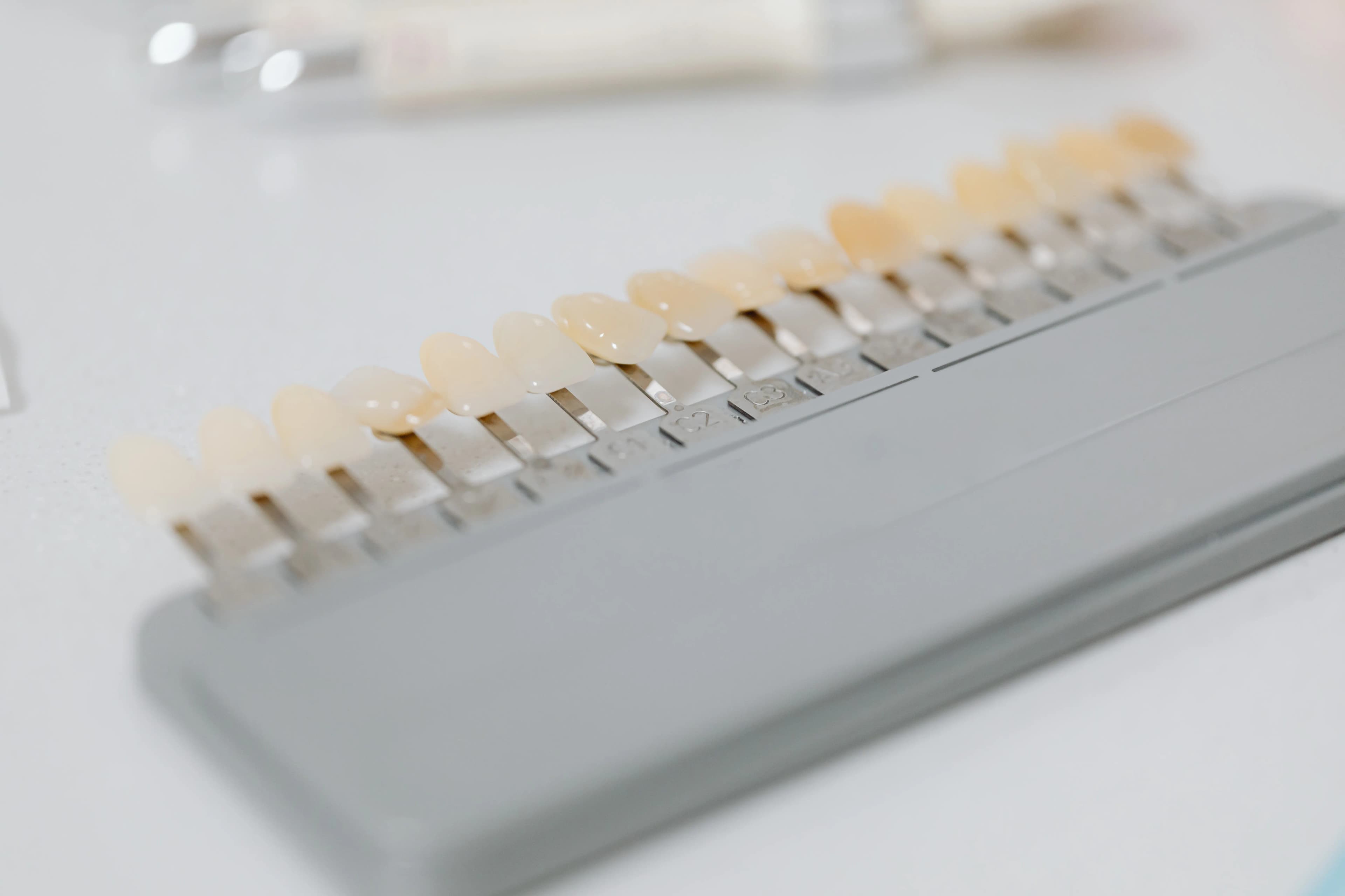 Cosmetic dentist reviewing a porcelain shade guide